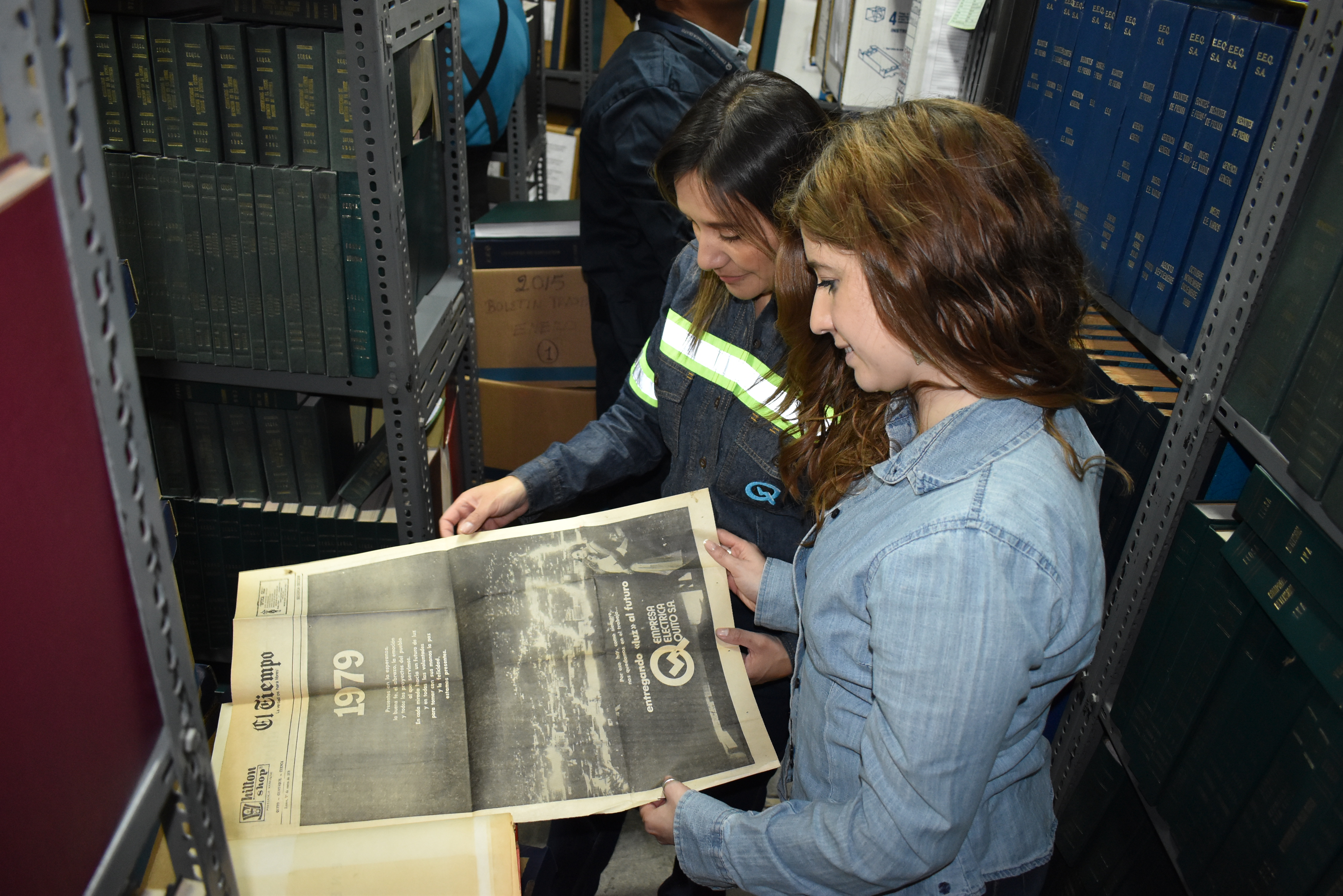 Ana Marcillo y Lorena Cordero, de la UTA, revisan una nota publicada por la EEQ en 1979 en el desaparecido diario El Tiempo, al revisar el tesoro histórico documental de la Empresa.